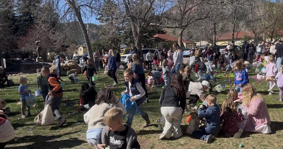 Kids gathering Easter eggs at the Village Green