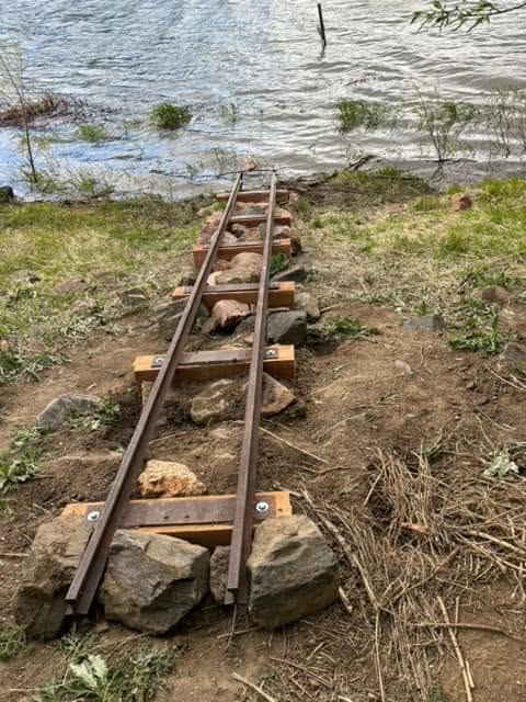 The finished staff gauge anchored into the shoreline near the pedestrian bridge