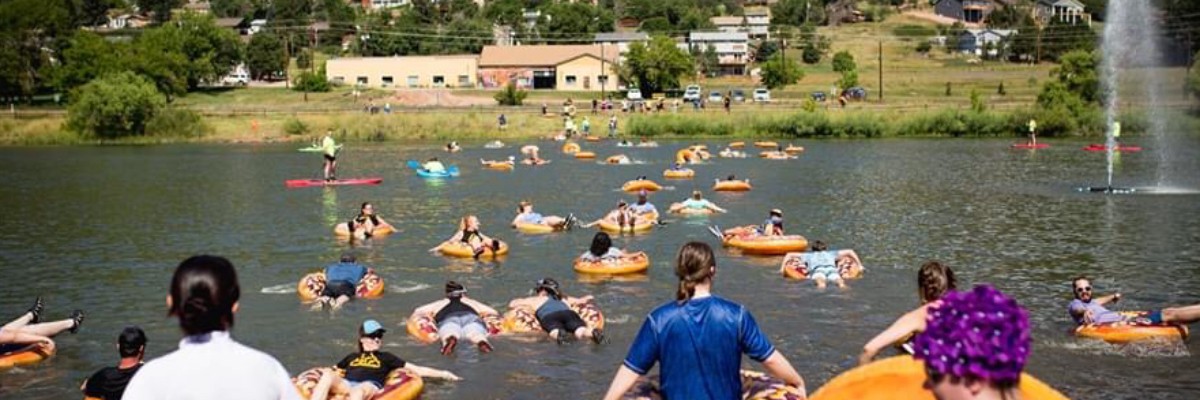 Competitors floating on inner tubes across Palmer Lake during the TRY-athlon